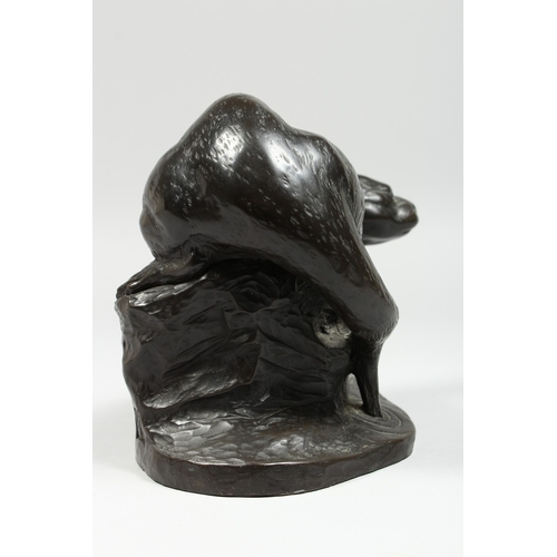 341 - A BRONZED FIGURE OF A OTTER on a rocky base,signed T Wick.