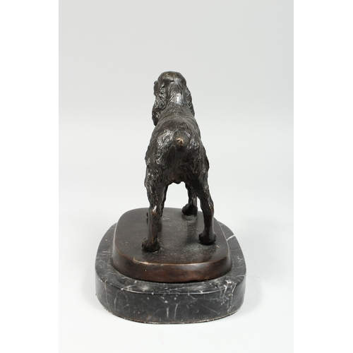 346 - A BRONZE SPANIEL on a marble base, 6 ins long.