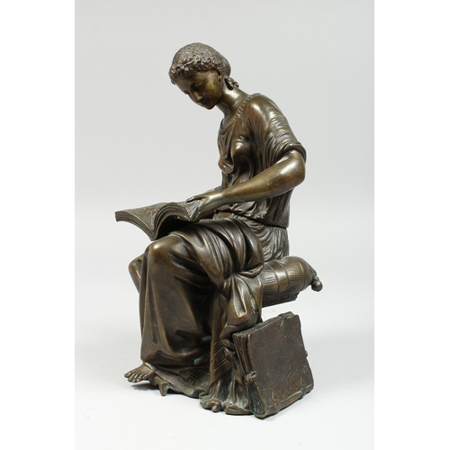 347 - A CLASSICAL BRONZE SEATED FIGURE reading a book, 10 ins high.