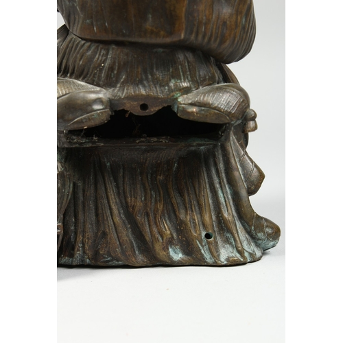 347 - A CLASSICAL BRONZE SEATED FIGURE reading a book, 10 ins high.