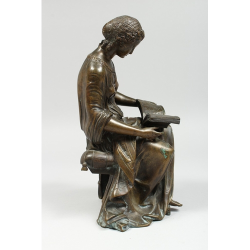 347 - A CLASSICAL BRONZE SEATED FIGURE reading a book, 10 ins high.