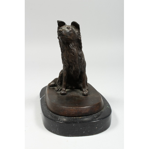 348 - A BRONZE DOG on a marble base. 5 ins high.