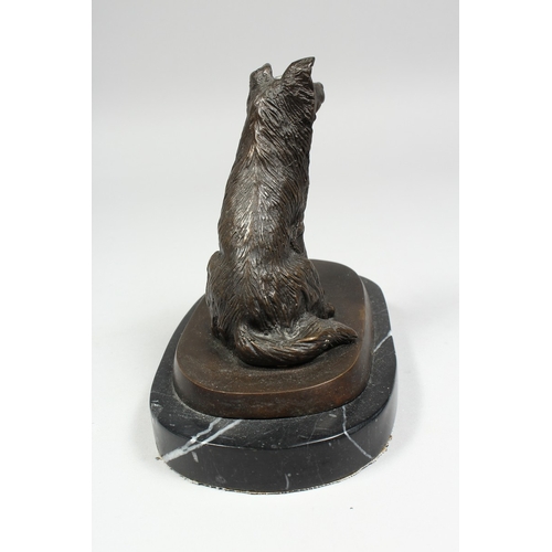 348 - A BRONZE DOG on a marble base. 5 ins high.