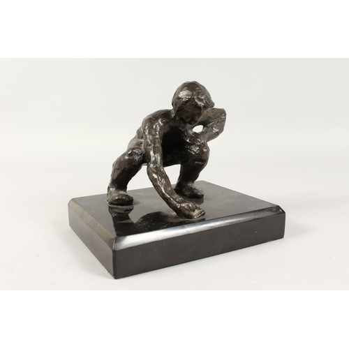 350 - JUGANDO CANICAS (MEXICAN) A BRONZE CROUCHING MAN. Signed, on a black marble base.  5ins high.... 