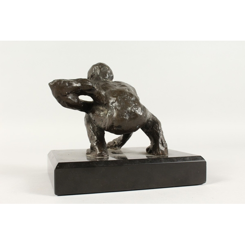 350 - JUGANDO CANICAS (MEXICAN) A BRONZE CROUCHING MAN. Signed, on a black marble base.  5ins high.... 