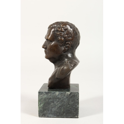 360 - AFTER THE ANTIQUE, A bronze bust on a marble plinth. 5 ins  high