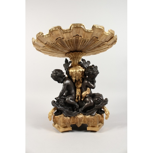 367 - A GOOD GILT AND BRONZE CENTREPIECE, three cupids holding a shell. 12 ins high.