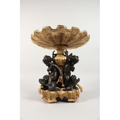 367 - A GOOD GILT AND BRONZE CENTREPIECE, three cupids holding a shell. 12 ins high.