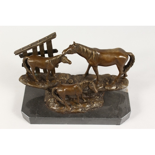 369 - A BRONZE GROUP OF THREE HORSES on a marble base. 10 ins long. 