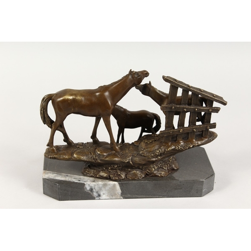 369 - A BRONZE GROUP OF THREE HORSES on a marble base. 10 ins long. 