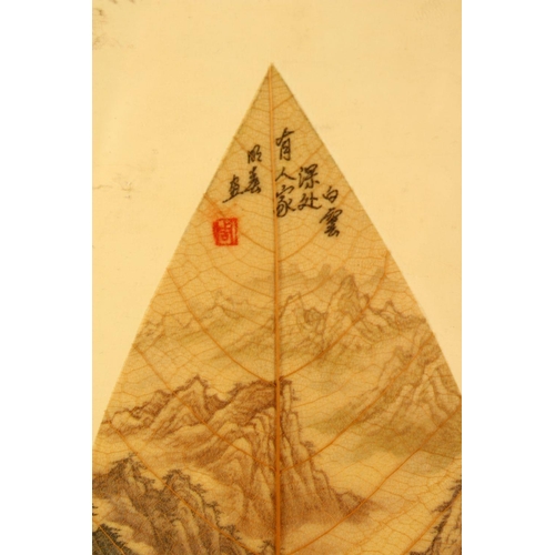 79 - A CHINESE PAINTED & FRAMED BANYAN LEAF, the leaf painted with scenes of a mountainous landscape, the... 