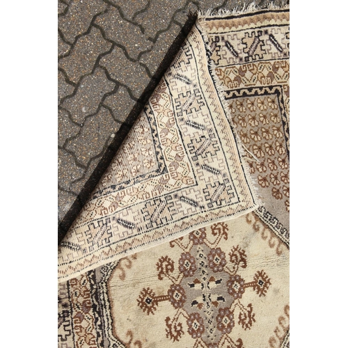 1008 - A PERSIAN RUG brown and cream with large medallions. 6ft 6ins long x 4ft 6ins wide