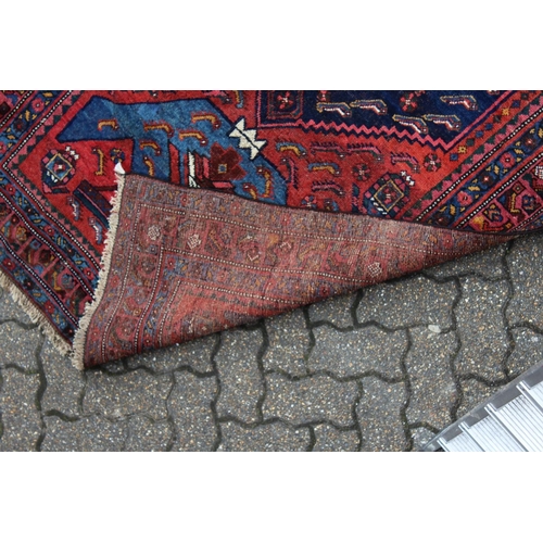 1022 - A GOOD SMALL PERSIAN RUG, deep red ground with a central large medallion, flanked by stylised vases.... 