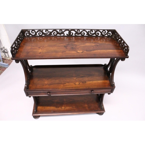1034 - A GOOD LATE REGENCY ROSEWOOD THREE TIER WHAT-NOT, with pierced gallery, three shelves, the centre on... 