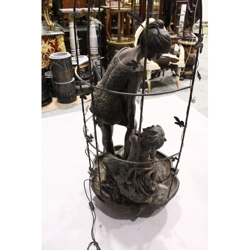 1043 - A FINE BRONZED WATER FEATURE, a classical female and Cupid standing on a metal base and arbour.