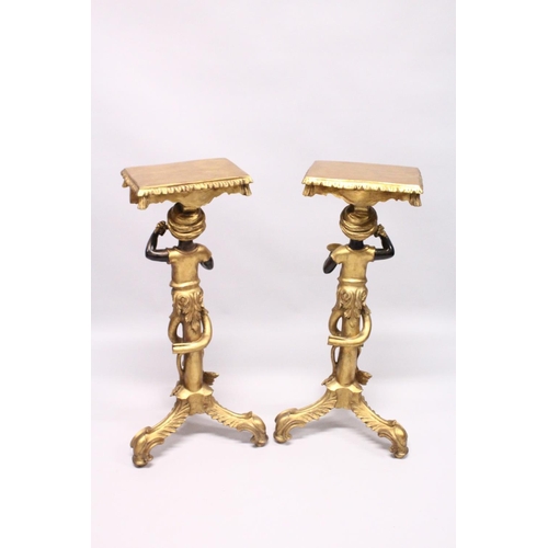 1046 - A GOOD PAIR OF EARLY 20TH CENTURY GILDED BLACKAMOOR STANDS with rectangular top, blackamoor supports... 