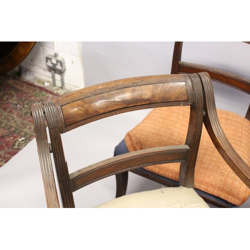 1052 - A PAIR OF MAHOGANY, SABRE LEG ARM CHAIRS and three matching single chairs.