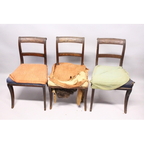 1052 - A PAIR OF MAHOGANY, SABRE LEG ARM CHAIRS and three matching single chairs.