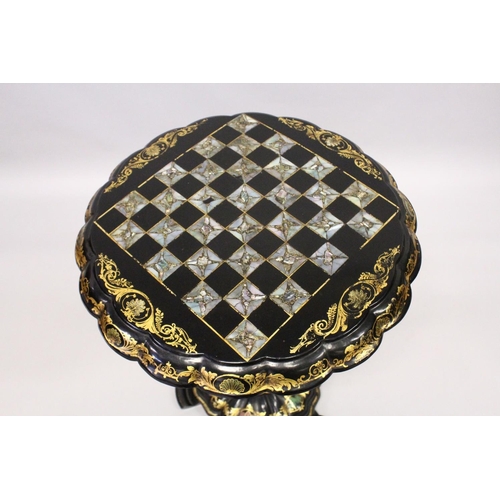 1053 - A VICTORIAN BLACK AND GILT PAPIER MACHE TILT TOP GAMES TABLE, with inlaid chess board in mother of p... 