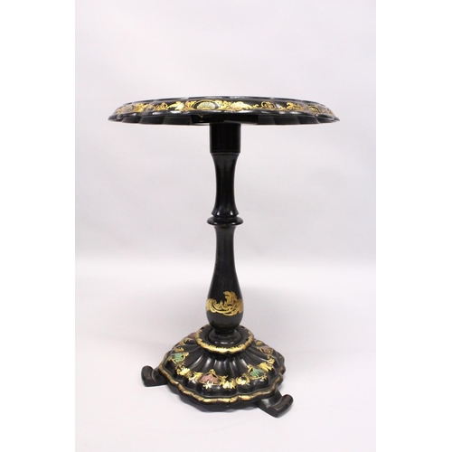 1053 - A VICTORIAN BLACK AND GILT PAPIER MACHE TILT TOP GAMES TABLE, with inlaid chess board in mother of p... 