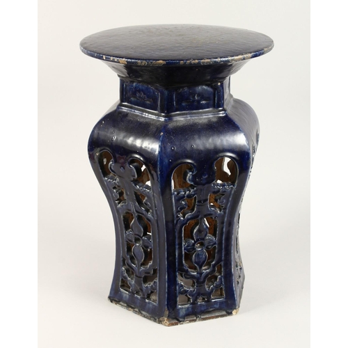 1088 - A CHINESE POTTERY SEAT with circular top and pierced sides. 1ft 8ins high.