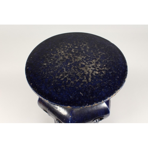 1088 - A CHINESE POTTERY SEAT with circular top and pierced sides. 1ft 8ins high.