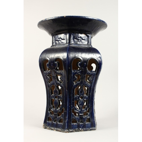 1088 - A CHINESE POTTERY SEAT with circular top and pierced sides. 1ft 8ins high.