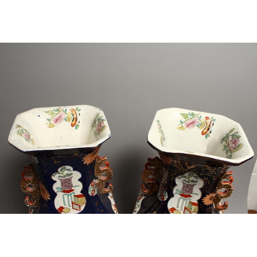 1186 - A LARGE PAIR OF IRONSTONE JAPAN PATTERN TWO HANDLED VASES with Chinese panels. 23ins high.