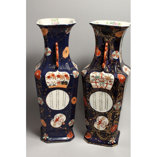 1186 - A LARGE PAIR OF IRONSTONE JAPAN PATTERN TWO HANDLED VASES with Chinese panels. 23ins high.
