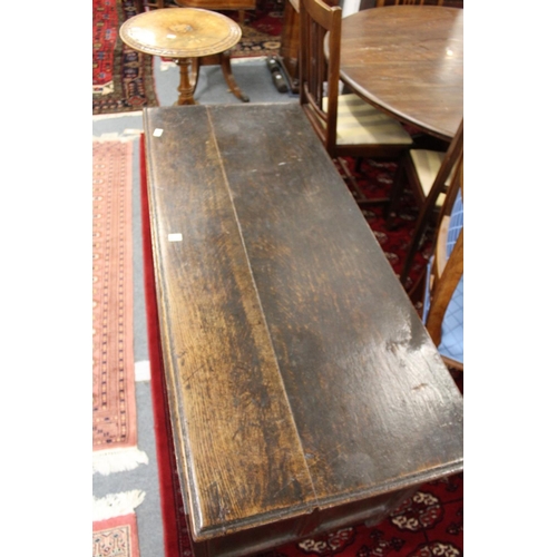 1047 - A LARGE 18TH CENTURY OAK COFFER with plain top, four carved panels to the front. 4ft 6ins wide.