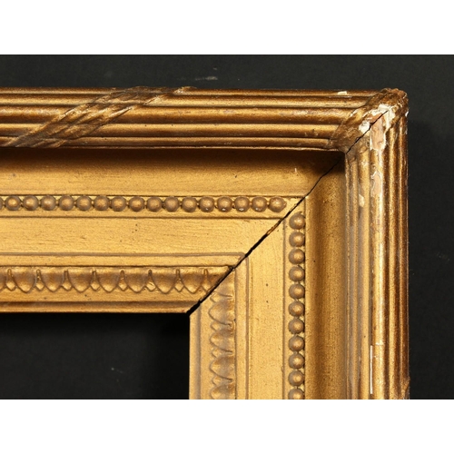 1017 - A 19th century gilt composition frame with moulded and ribbon tied top ornament, rebate size 13  x 1... 