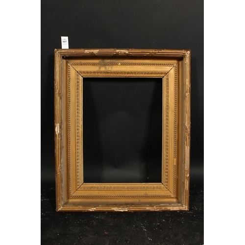 1017 - A 19th century gilt composition frame with moulded and ribbon tied top ornament, rebate size 13  x 1... 