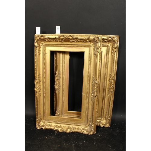 1021 - A pair of 19th century gilt composition swept frames, rebate size each 10  x 20 , 25.5cm x 51cm.
