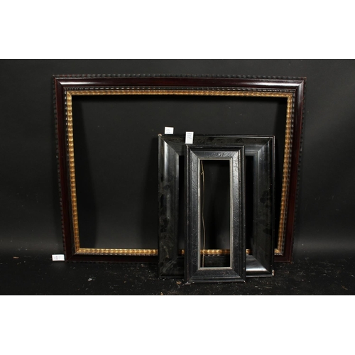 1024 - A Dutch style ripple moulded frame, rebate size 24.5  x 32.5 , 62cm x 83cm along with two ebonised f... 