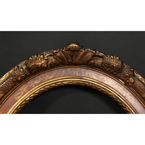 1041 - A 19th century oval frame with flowered cartouches and incised scrolling, rebate size 19.25  x 15 , ... 