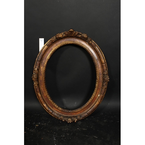 1041 - A 19th century oval frame with flowered cartouches and incised scrolling, rebate size 19.25  x 15 , ... 