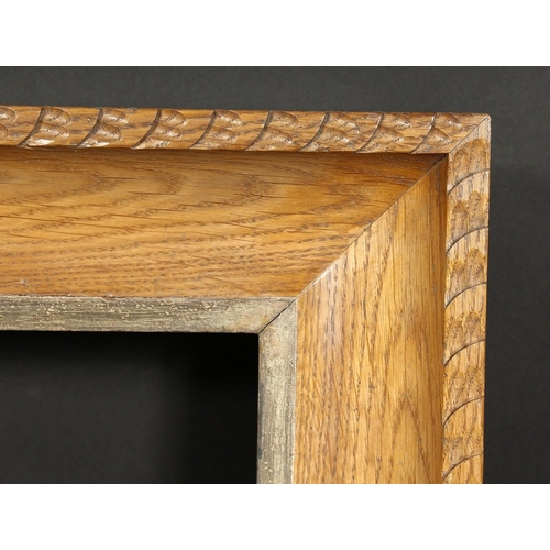 1050 - A carved oak frame with silvered inner ornaments, rebate size 24  x 36 , 61cm x 92cm.