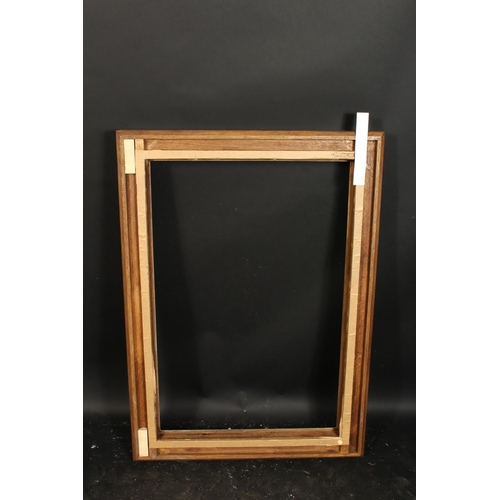 1050 - A carved oak frame with silvered inner ornaments, rebate size 24  x 36 , 61cm x 92cm.
