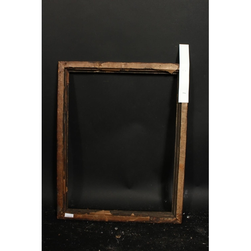 1052 - An 18th century carved and ebonised frame with a gilded inner ornament, rebate size 16  x 20.25