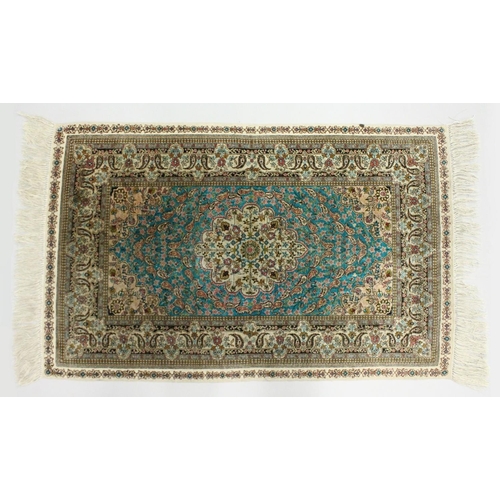 1003 - A SMALL PERSIAN SILK RUG, pale blue ground with fine floral design. 4ft x 2ft 6ins.