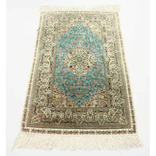 1003 - A SMALL PERSIAN SILK RUG, pale blue ground with fine floral design. 4ft x 2ft 6ins.