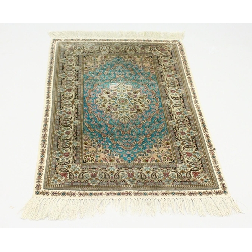 1003 - A SMALL PERSIAN SILK RUG, pale blue ground with fine floral design. 4ft x 2ft 6ins.