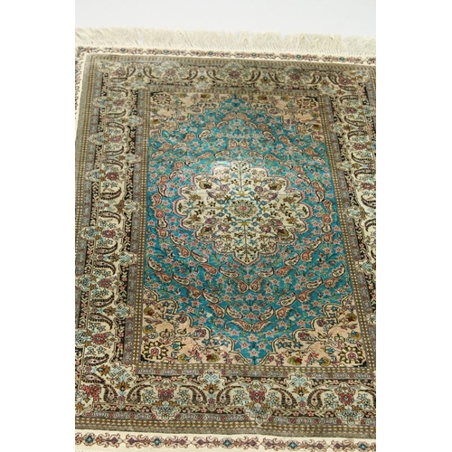 1003 - A SMALL PERSIAN SILK RUG, pale blue ground with fine floral design. 4ft x 2ft 6ins.