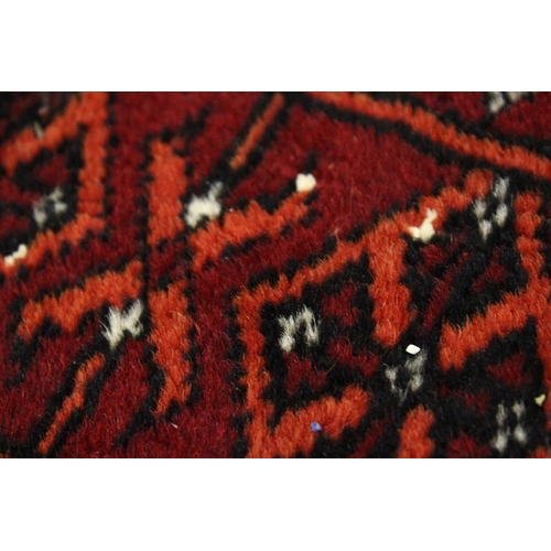 1005 - A BOKHARA RUG, red ground with a single row of nine gulls (worn). 5ft 3ins  x 3ft 4ins.