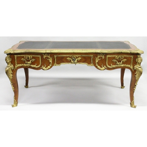 1011 - A GOOD LOUIS XVI DESIGN KINGWOOD AND ORMOLU BUREAU PLAT, of shaped outline, with gilt tooled leather... 