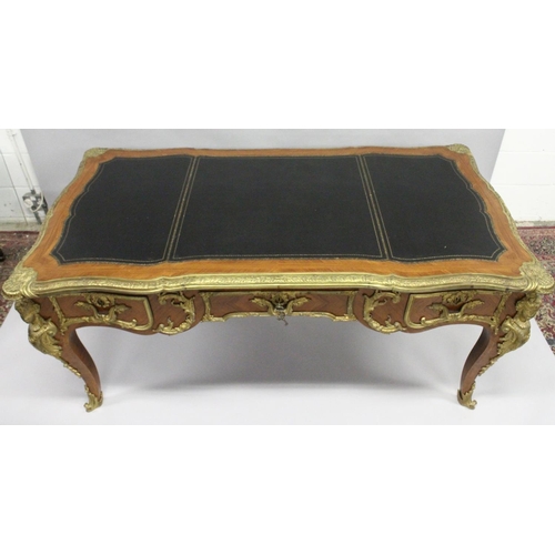 1011 - A GOOD LOUIS XVI DESIGN KINGWOOD AND ORMOLU BUREAU PLAT, of shaped outline, with gilt tooled leather... 