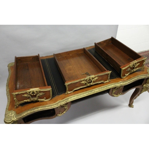 1011 - A GOOD LOUIS XVI DESIGN KINGWOOD AND ORMOLU BUREAU PLAT, of shaped outline, with gilt tooled leather... 