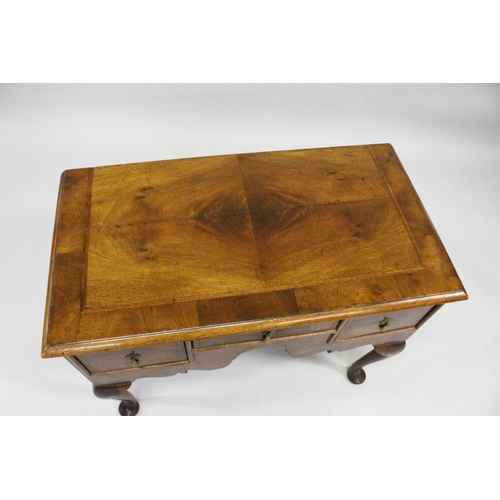 1018 - AN 18TH CENTURY WALNUT LOWBOY with a cross banded and feather banded quarter veneered top, three dra... 