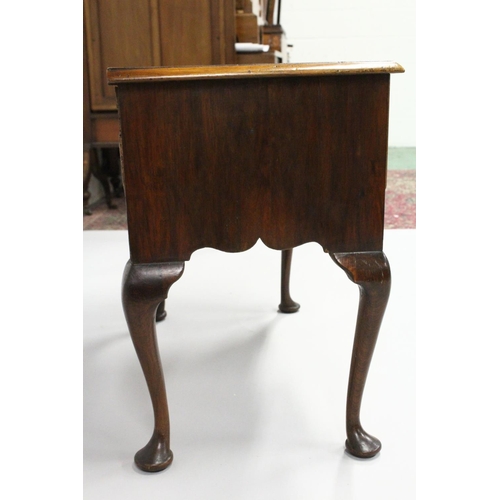 1018 - AN 18TH CENTURY WALNUT LOWBOY with a cross banded and feather banded quarter veneered top, three dra... 