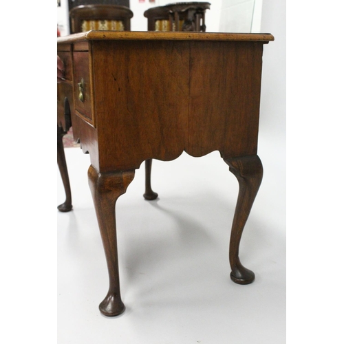 1018 - AN 18TH CENTURY WALNUT LOWBOY with a cross banded and feather banded quarter veneered top, three dra... 